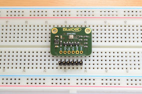 Placing board on breadboard before soldering header